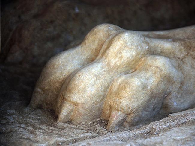 Lion’s paw ... A front paw of a large stone sphinx is seen topping the entrance to an ancient tomb under excavation at Amphipolis in northern Greece. Source: AP