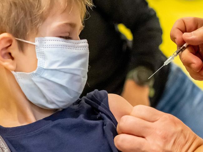 A doctor inoculates 5-year-old Phillip with the first dose of the Pfizer-BioNTech vaccine. Picture: Hannibal Hanschke