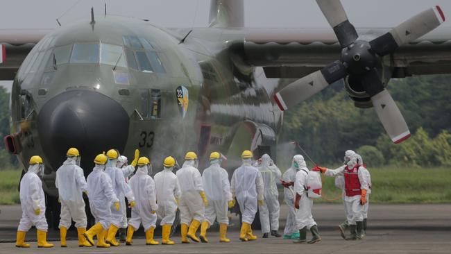 Troops and health officials in Jakarta prepare to unload medical supplies flown from Shanghai on Monday. Picture: AFP