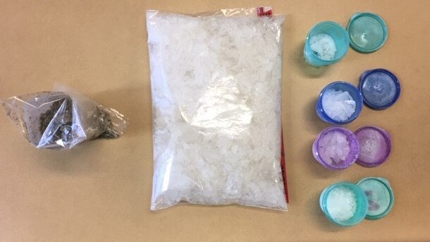 Police allegedly located a large quantity of methamphetamine and drug lab equipment at a house at Helensvale.