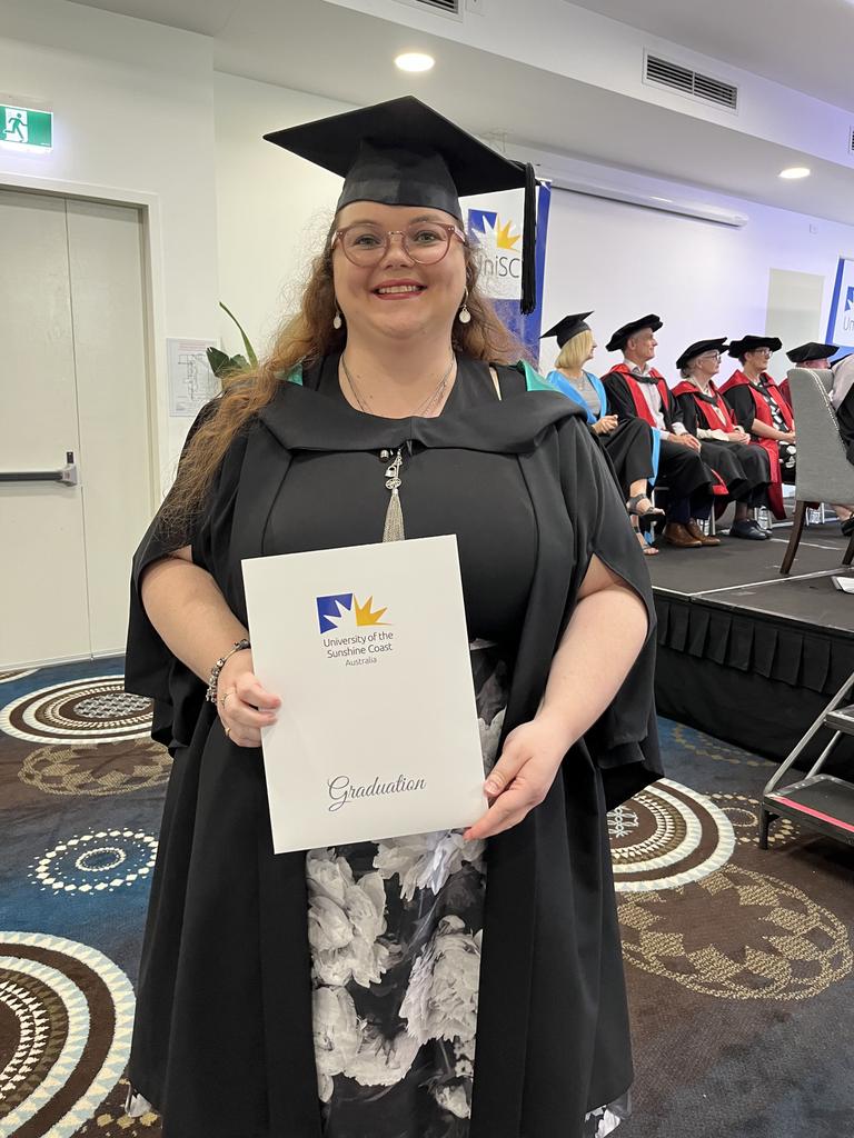 Kyra Lollback with her certificate after completing a Bachelor of Animal Ecology.