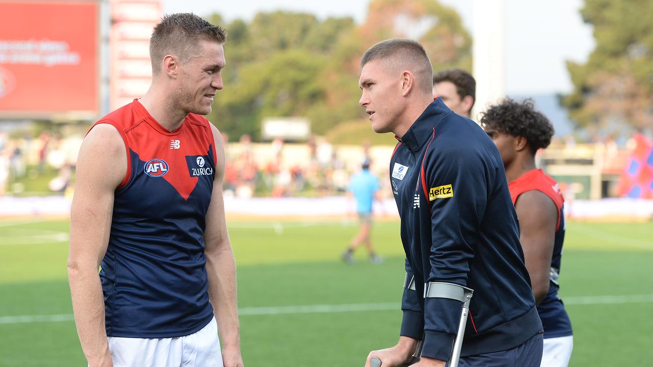 Tom McDonald, left, and injured teammate Adam Tomlinson after the win over the Kangaroos. Picture: Steve Bell/AFL Photos.