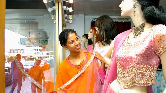 A shop assistant measures up in a Fijian-themed shop in Liverpool in 2004. Picture: Dean Marzolla