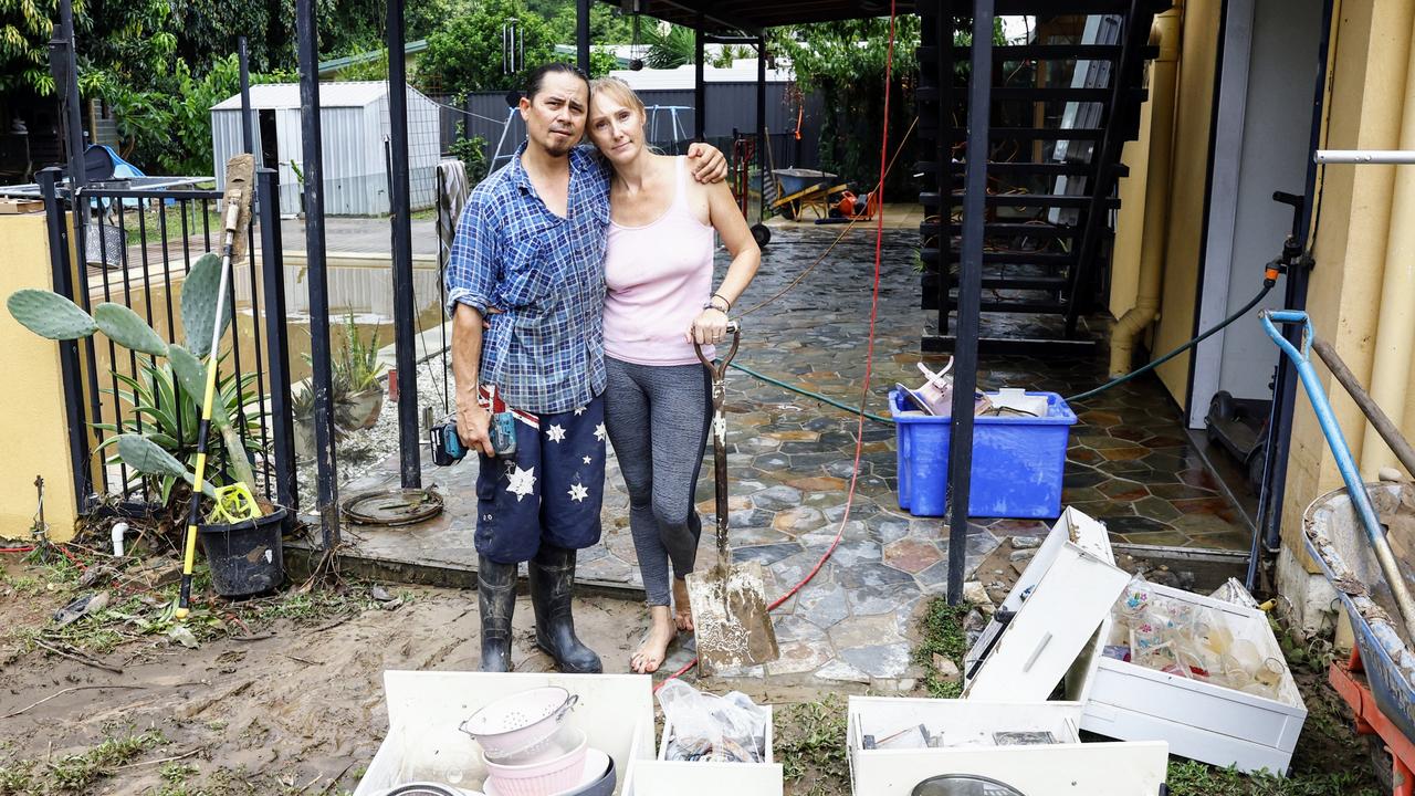 Caravonica residents Chris King and Krystal King comfort each other while cleaning up the flood water that inundated their Lake Placid Road home on Sunday night. Picture: Brendan Radke