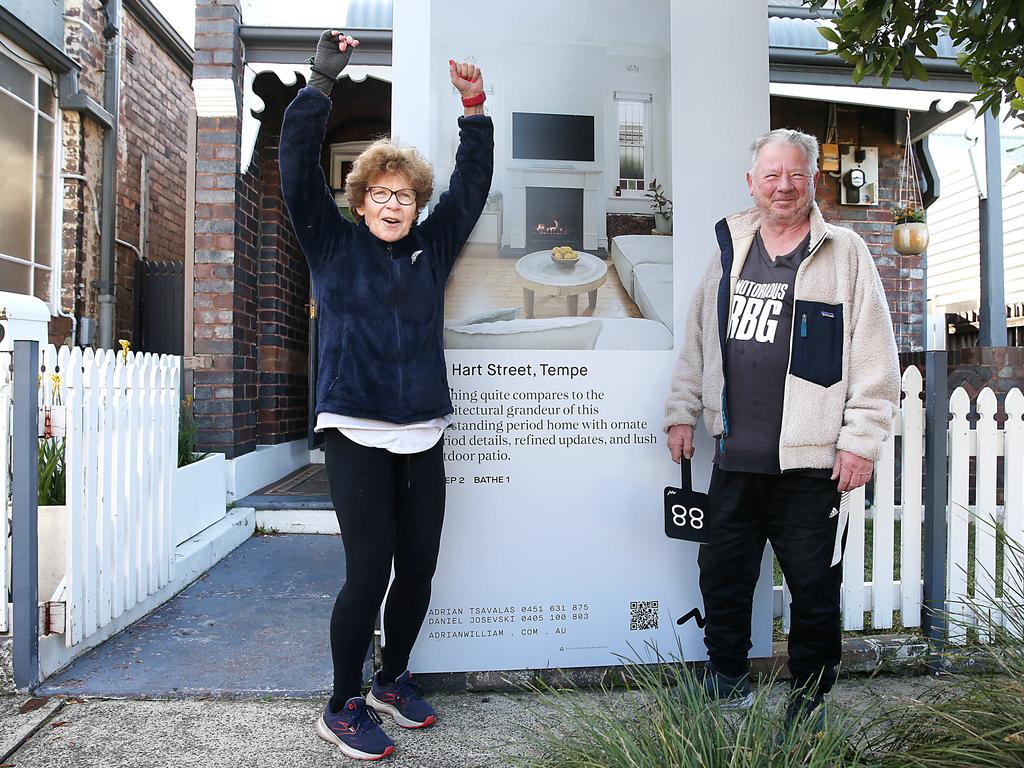 Winning bidder John Denny with his sister Libby celebrate outside the Tempe home. Picture: Jane Dempster