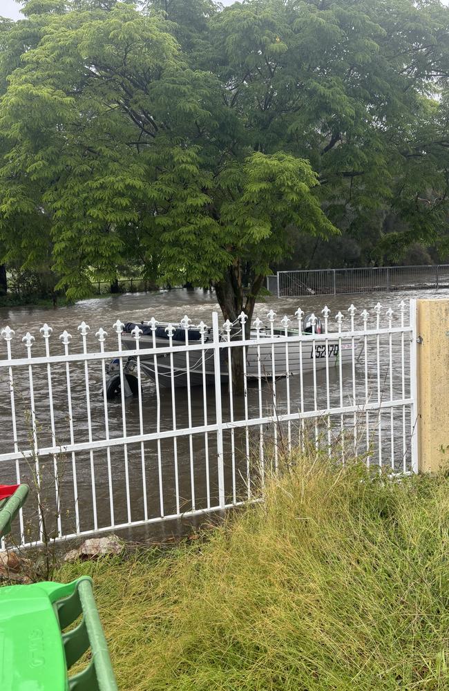 Floodwater rises to a resident's gate in Birkdale in Redland City on Saturday. Picture: Carl Dahl