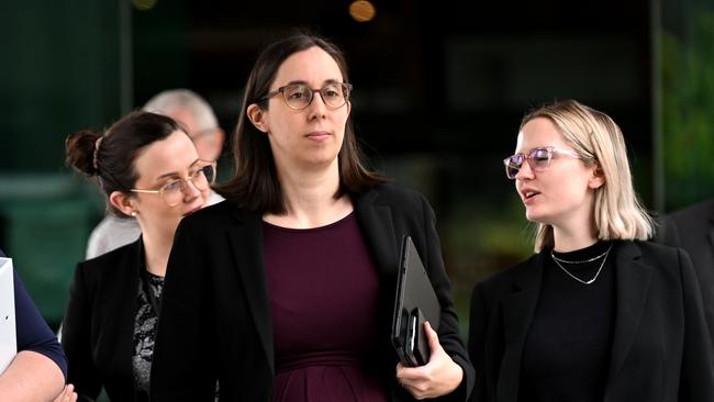 Susan Hedge, centre, leaves the Commission of Inquiry into Forensic DNA testing in Queensland at the Brisbane Magistrates Court. Picture: Dan Peled