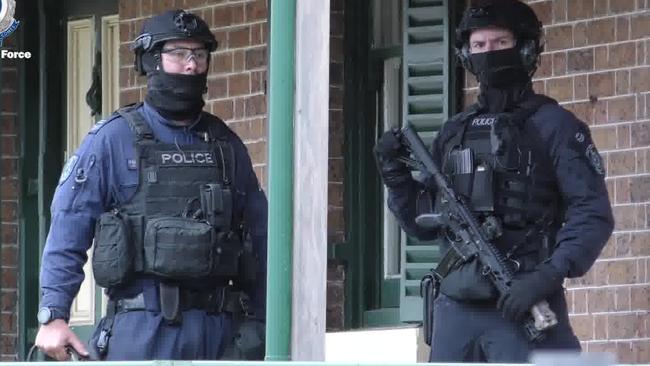 Heavily armed police during raid yesterday. Pictures: NSW Police