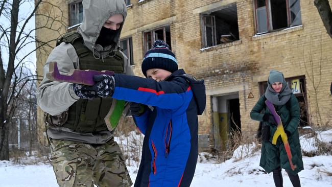 Ukraine residents train on the outskirts of Kiev on Sunday with wooden replicas of Kalashnikov rifles. Picture: AFP