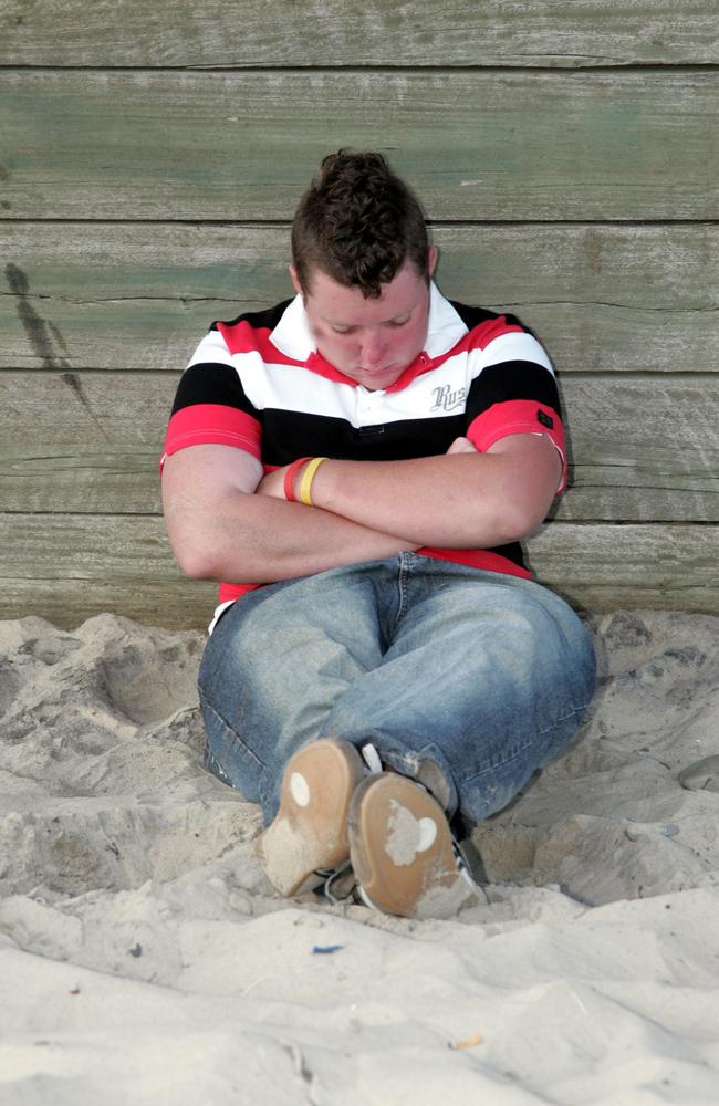 A man enjoys a snooze on the beach to kick off the new year in 2007. Picture: David Thomas.