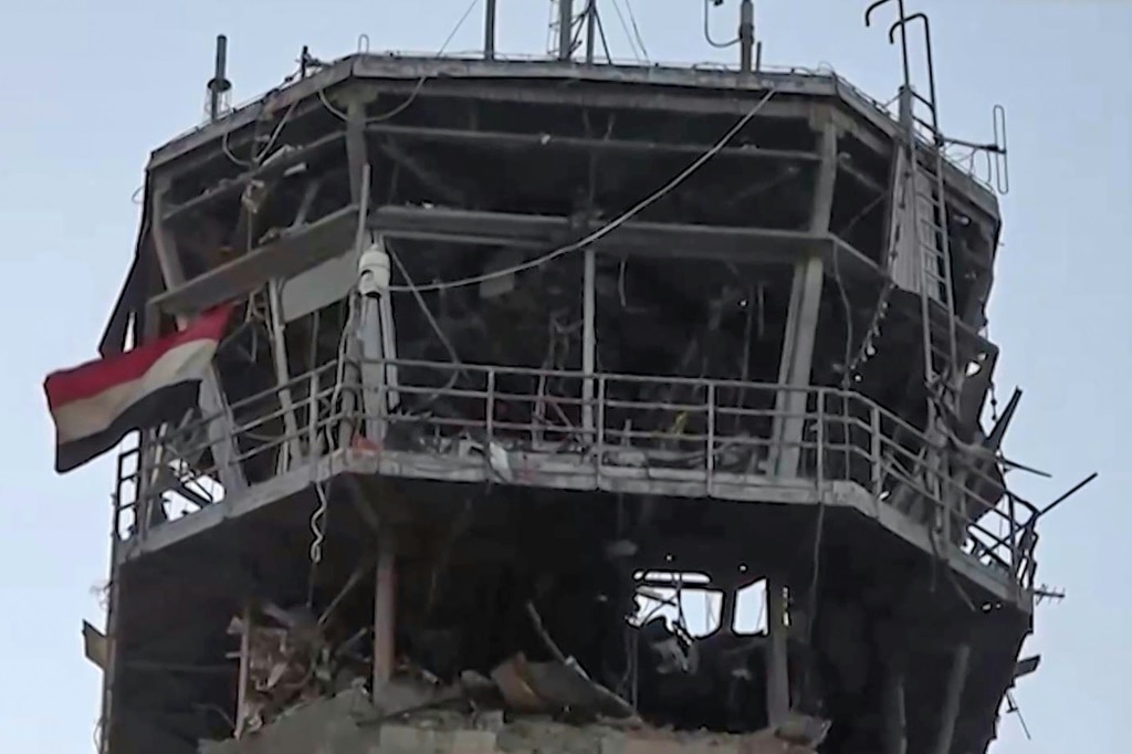 An image taken from a handout video provided by the Huthis' official Al-Masirah TV station shows the damage to the airport from an Israeli strike