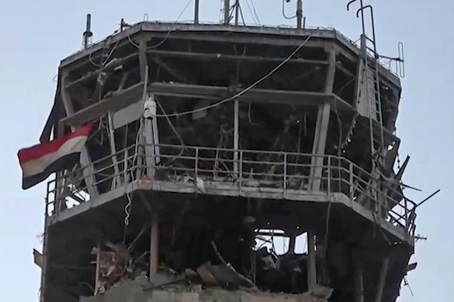 An image taken from a handout video provided by the Huthis' official Al-Masirah TV station shows the damage to the airport from an Israeli strike