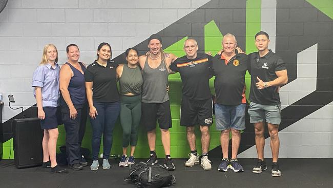 Adam Drake, fourth from right, at Darwin's Next Level Gym after completing 52 push-ups in one minute while carrying a 100lb pack, setting a new world record. Picture: Supplied