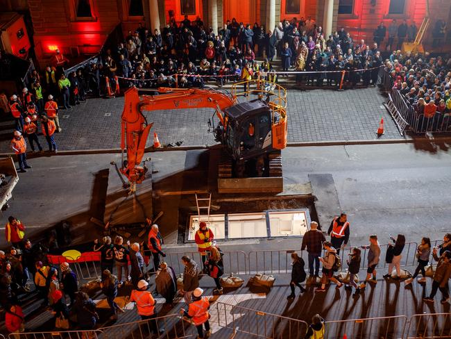 A large crowd turned out to watch Mike Parr be buried under Macquarie St. Picture: DARK MOFO