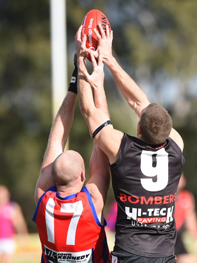 Frankston Bombers playing-coach Beau Muston (right) takes a strong mark in front of Rye’s James Appleford. Picture: Chris Eastman