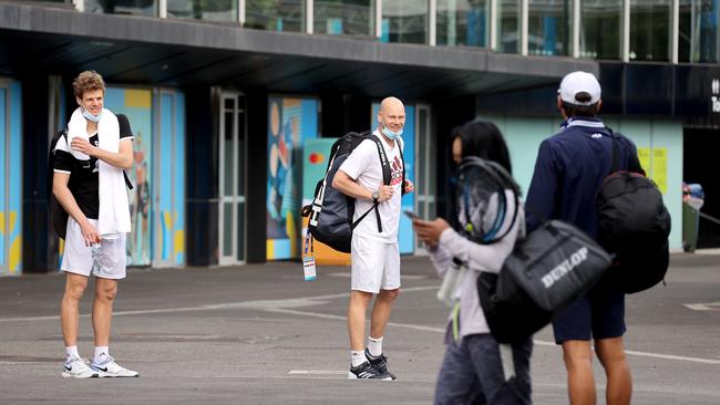 German tennis player Yannick Hanfmann, left, arrives with other players for a training session at the Australian Open venue in Melbourne today. Picture: AFP