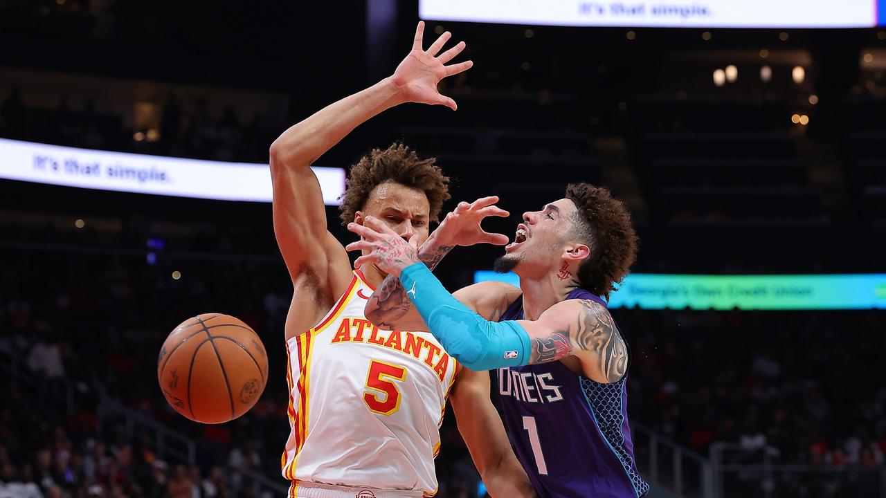 LaMelo Ball draws a foul from Dyson Daniels. (Photo by Kevin C. Cox/Getty Images)