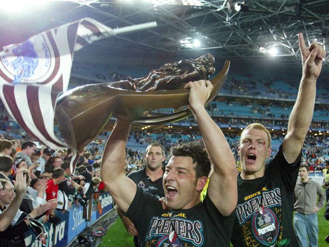 OCTOBER 5, 2003 : Penrith Panthers captain Craig Gower proudly displays premiership trophy to fans at Telstra Stadium, Homebush following 05/10/03 defeat of Sydney Roosters in NRL grand final, followed by teammate Luke Lewis. Pic Gregg Porteous.Rugby League