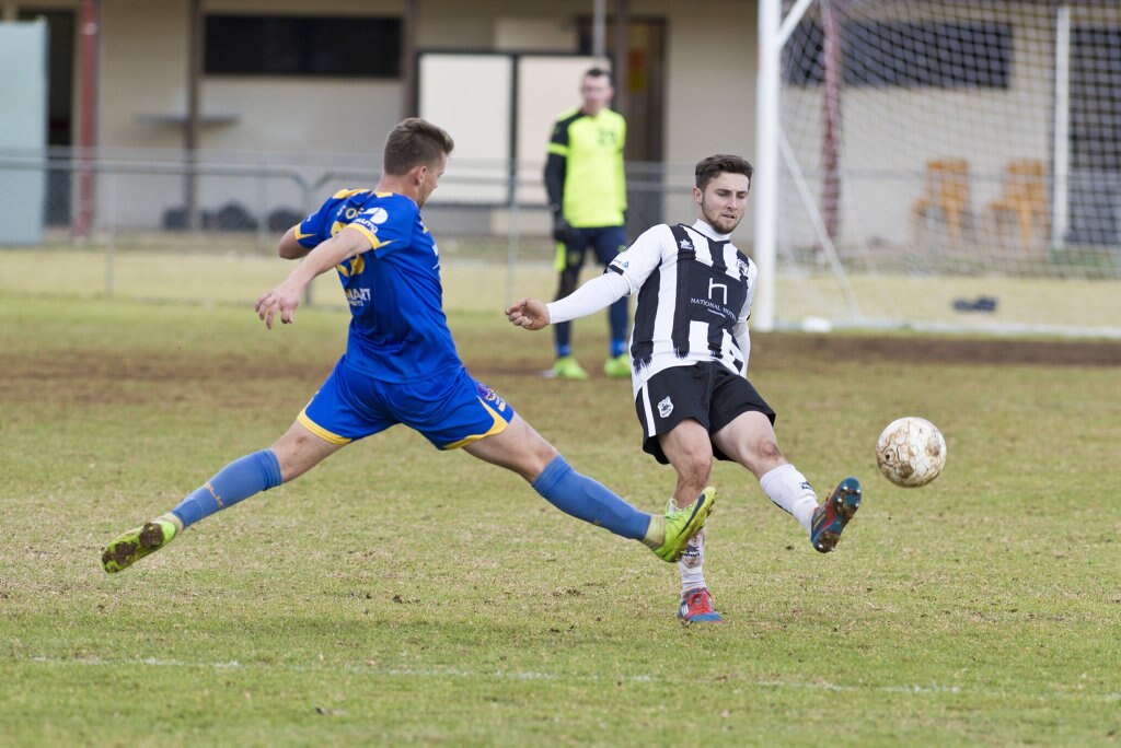 Jacob Stoner (left) of USQ FC attempts to block a kick from Nik Lawson of Willowburn in Toowoomba Football League Premier Men semi-final at Commonwealth Oval, Sunday, August 26, 2018. Picture: Kevin Farmer