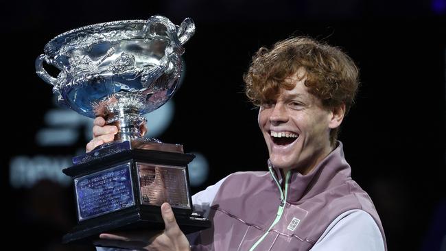 Italy's Jannik Sinner celebrates with the Norman Brookes Challenge Cup trophy after defeating Russia's Daniil Medvedev in the men's singles final match of the Australian Open tennis tournament in Melbourne.