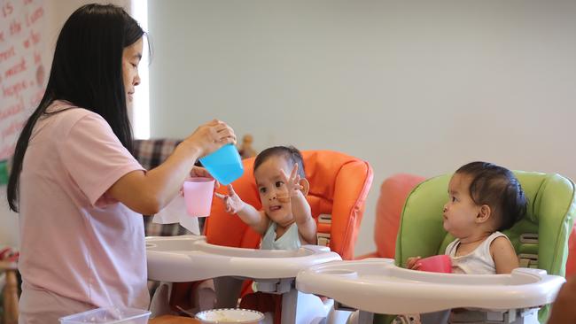 The twins Dawa (left), and Nima (right) are learning to feed themselves and increasingly tolerate food by having lunch with the other kids at the retreat. Picture: Alex Coppel