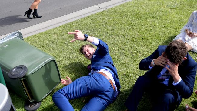 Racegoers are seen on the ground after the Melbourne Cup.