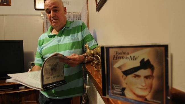 Gary Ivory, looks through the memorabilia of his great-uncle, Edward 'Teddy' Sheean, who was killed in 1942 after HMAS Armidale was attacked by Japanese warplanes in the Arafura Sea, en route to Timor. Sheean did not leave his post and his bravery was mentioned in dispatches. Ivory says that it is time to give his relative a VC, pictured at his home in Launceston, Tasmania.