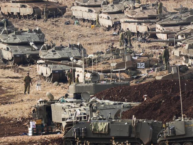 Israeli soldiers work on tanks at a staging area in northern Israel near the Israel-Lebanon border, Tuesday, Oct. 1, 2024. (AP Photo/Baz Ratner)