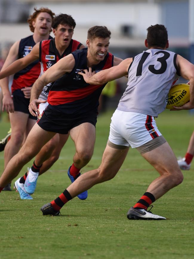 Bairnsdale coach, Logan Austin, attempts to tackle Maffra forward, John Butcher. Picture supplied: Bairnsdale Advertiser