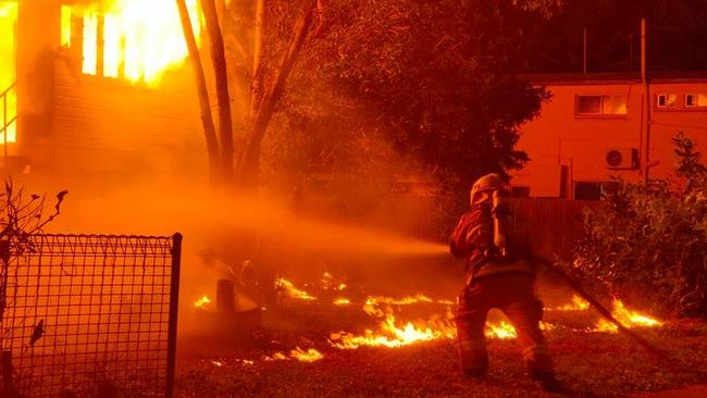 Firefighting crews battling to extinguish a house blaze on Sheridan St in Cairns North. Picture: Peter Carruthers