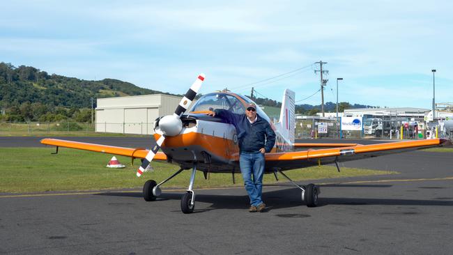 FLYING PAROTS: Gary Herne with his brightly painted CT-4 basic trainer, in which a generation of Australian Defence Force (ADF) pilots made a first, anxious solo flight.