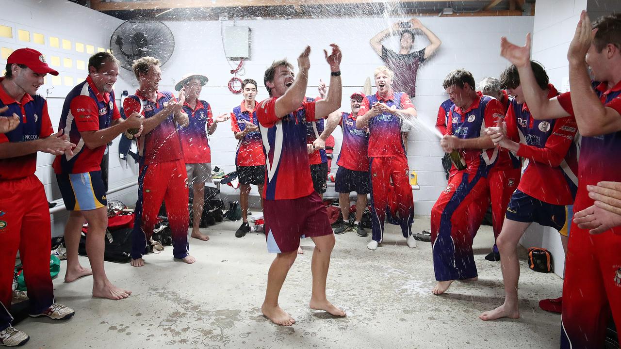 Mulgrave bowler Will Robertson has champagne sprayed over him by team mates Jake Roach (left) and captain Justin Reid (right), after claiming victory in the Cricket Far North Grand Final match between Rovers, held at Griffiths Park. Picture: Brendan Radke