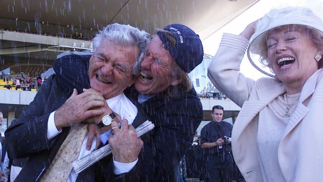 Singleton, centre, celebrates with former PM Bob Hawke and his wife Blanche d'Alpuget after their horse won the Golden Slipper in 2000.