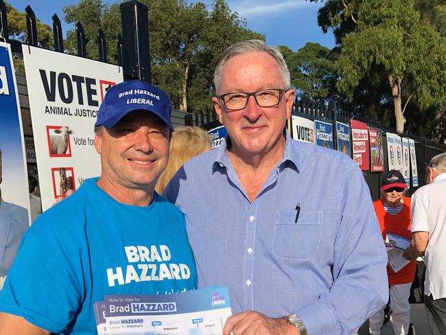 Liberal MP for Wakehurst, Brad Hazzard, with an election volunteer outside Allambie Heights Community Centre. 