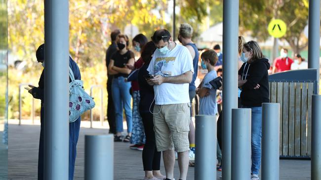 People line up at at a new testing staton at Thebarton Community Centre on Monday. Picture: Tait Schmaal