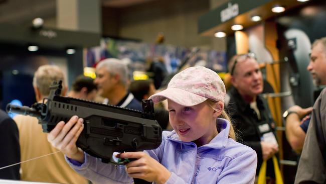 Bailey Chappuis, 12, holds a Beretta ARX 160 during a National Rifle Association meeting in St Louis, Missouri. Picture: Whitney Curtis/Getty