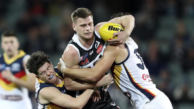 Port Adelaide’s Peter Ladhams under pressure from Adelaide’s Ned McHenry and Darcy Fogarty. Picture: SARAH REED