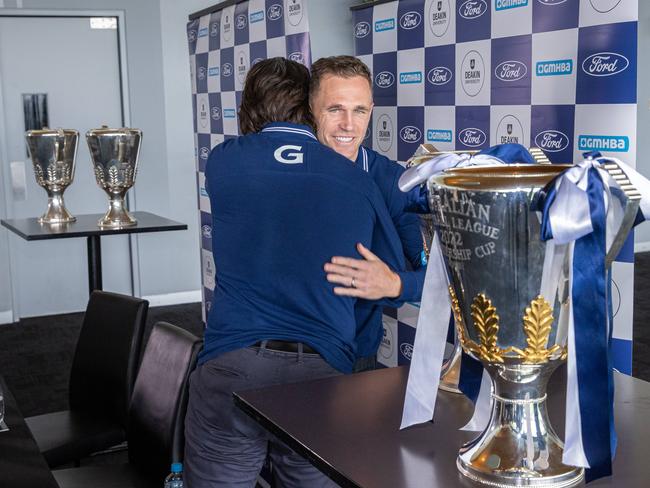 Joel hugs Chris Scott within sight of the premiership cup. Picture: Jason Edwards