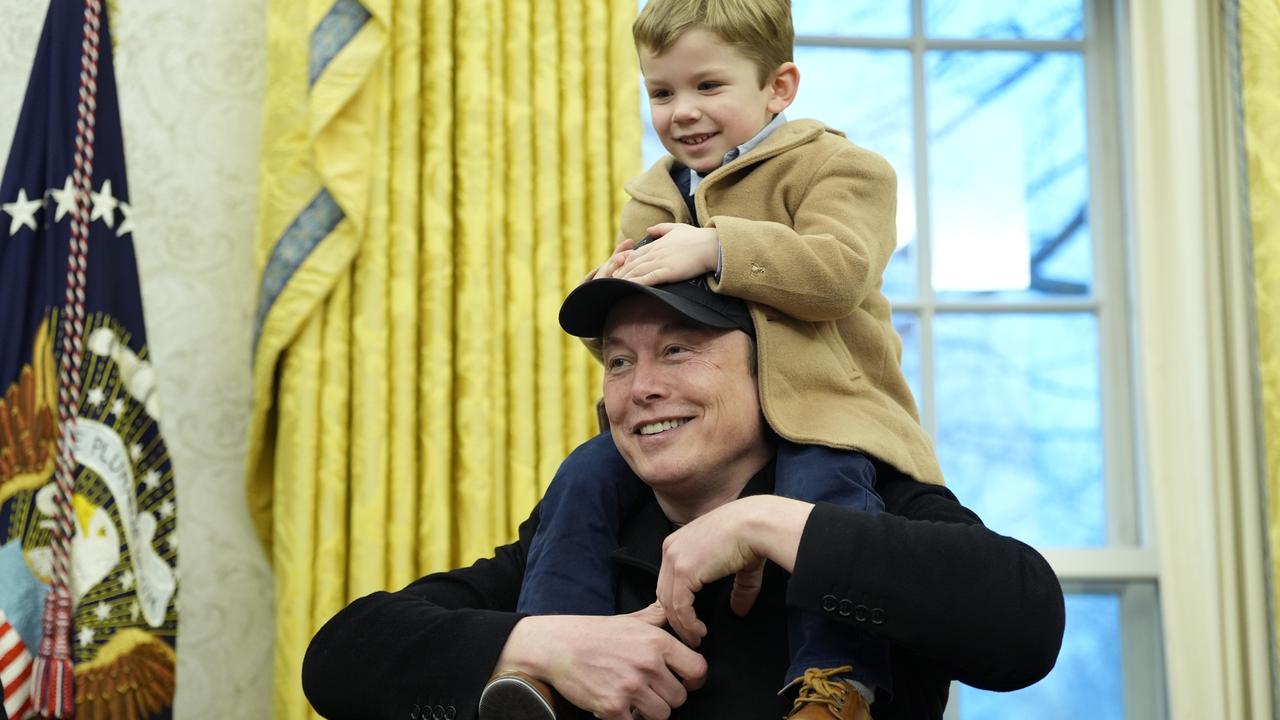 Mr Musk answering questions with his young son on his shoulders. Picture: Alex Brandon