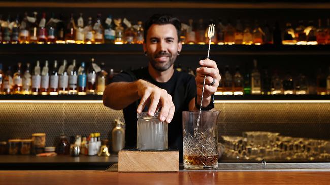 Three Wolves co owner Andrew Paré, prepares a smoke on the water cocktail, with bourbon whisky, cinnamon and bitters smoked with red cedar. Picture: Brendan Radke