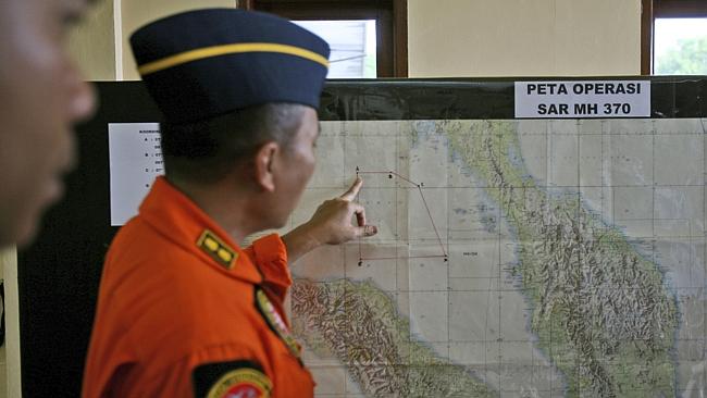 An Indonesia air force officer shows a map of Malacca Strait during a briefing at Suwondo air base in Medan, North Sumatra, Indonesia, Authorities hunting for the missing Boeing 777 have expanded their search areas to cover land and sea.