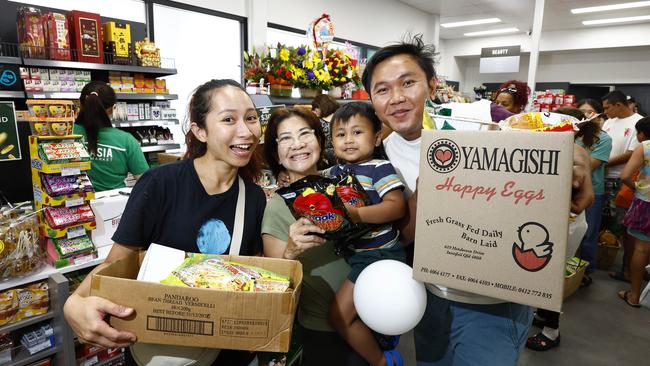 Big Asia Supermarket has opened a brand new, purpose built store with an expanded offering of Asian foods, and for the first time, alcohol. Indonesian customers Tika Jaya, Eve Setiawan, Skye Jaya, 3, and SJ Jaya queued for 30 minutes to buy some traditional Balinese food. Picture: Brendan Radke