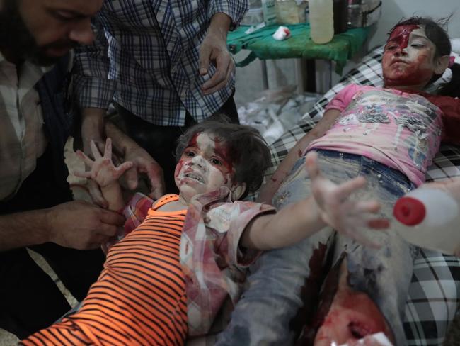 Spot News - Second Prize, Singles © Abd Doumany, Agence France-Presse Title: Medics Assist a Wounded Girl A Syrian girl cries out as a wounded child lies next to her at a makeshift hospital on 12 September 2016. She had been injured in reported government airstrikes on the rebel-held town of Douma, east of Damascus, Syria.