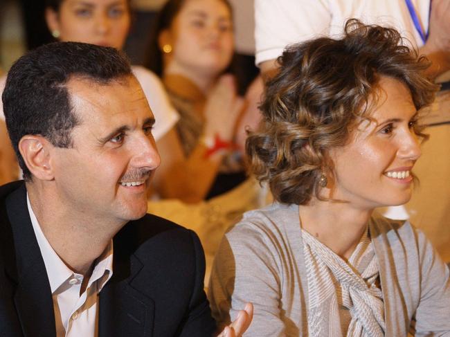 (FILES) Syria's ousted president Bashar Assad and his wife Asma visit a group of young athletes of special needs gathered at a hotel in Damascus late on September 5, 2010, ahead of the opening of the annual Middle East and North Africa Special Needs Olympics. Once seen as an advocate of women's rights in the Middle East, Syria's British-born former first lady Asma al-Assad has fled into exile with her husband, with UK officials saying she is not welcome home. (Photo by Louai BESHARA / AFP)