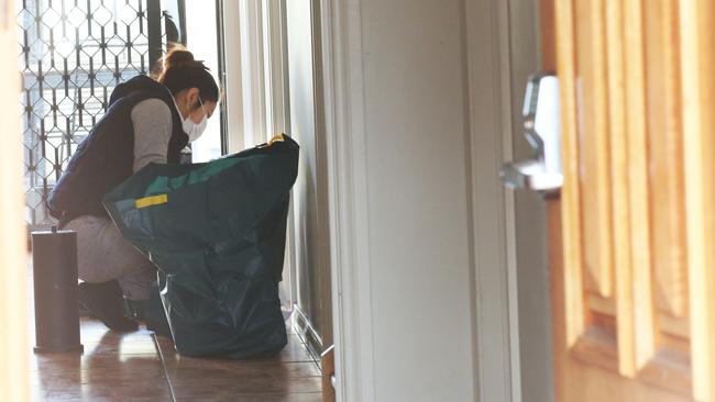 A woman cleaning inside the trashed house in Ryan St, Footscray. Picture: David Crosling