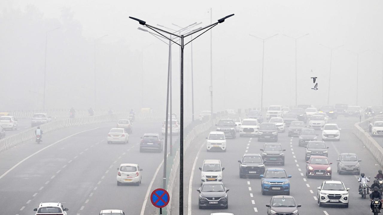 Commuters drive amid dense smog. Picture: Arun Sankar/AFP