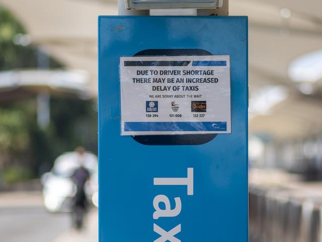 Signs at the Darwin International Airport apologise for the delay in wait times. Picture: Floss Adams.