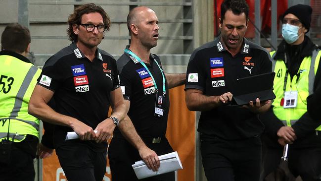 Mark McVeigh (middle) brought fellow ex-Bombers James Hird (left) and Dean Solomon into the coaches’ box with him at the Giants. Picture: Phil Hillyard