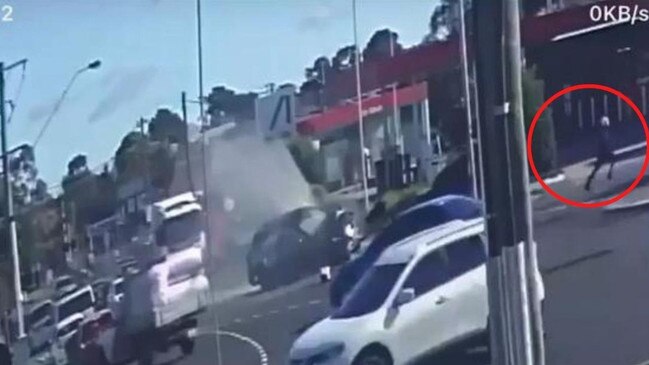 A still from the footage shows one of the alleged gunmen running from the crashed Mazda.