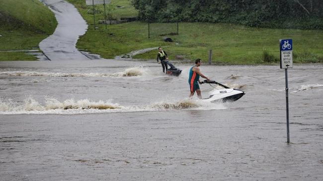 Jet ski's at Weedons Crossing playing in a flooded Nerang River during ex-Tropical Cyclone Debbie floods. Photo: Luke Sorensen.